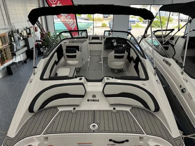 Slide: The Image of 2024 Yamaha Boats SX195 interior, featuring sleek seating and modern design in a showroom. - 3