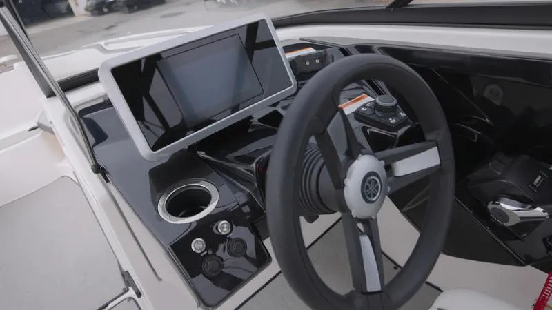 Slide: The Image of 2023 Yamaha Boats AR250 dashboard with touchscreen display and steering wheel. - 6
