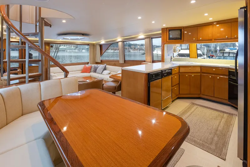 Slide: The Image of Luxurious interior of 2000 Viking 72 Convertible yacht with modern kitchen and dining area. - 12