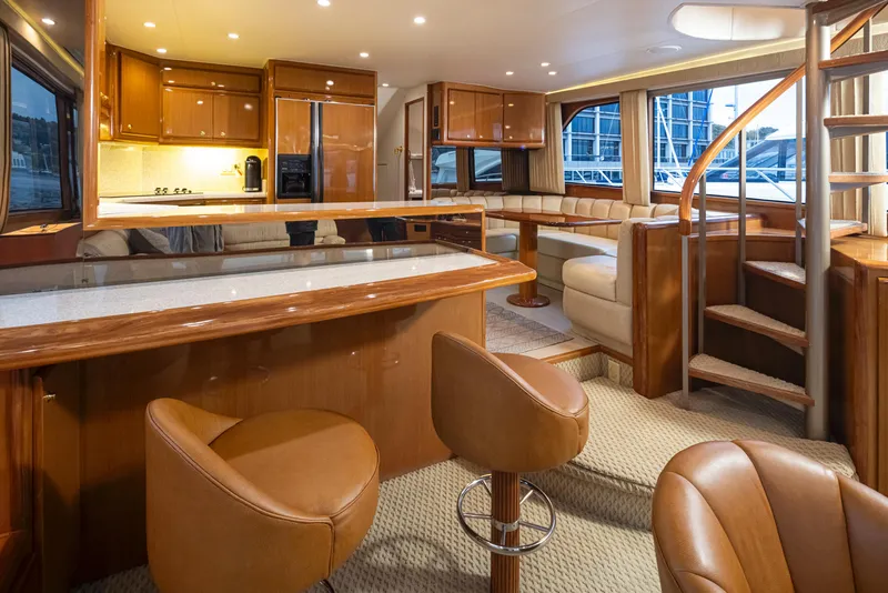 Slide: The Image of Luxurious interior of 2000 Viking 72 Convertible yacht with modern kitchen and seating area. - 13