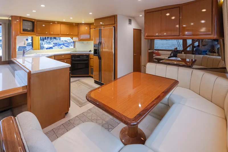 Slide: The Image of Spacious interior of 2000 Viking 72 Convertible yacht with modern kitchen and dining area. - 18