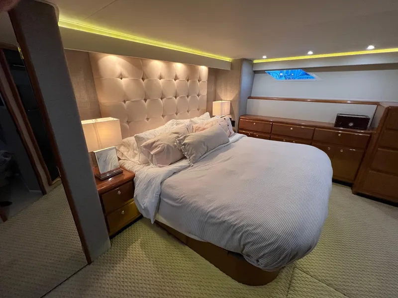 Slide: The Image of Luxurious bedroom interior of 2000 Viking 72 Convertible yacht with plush bedding and ambient lighting. - 19