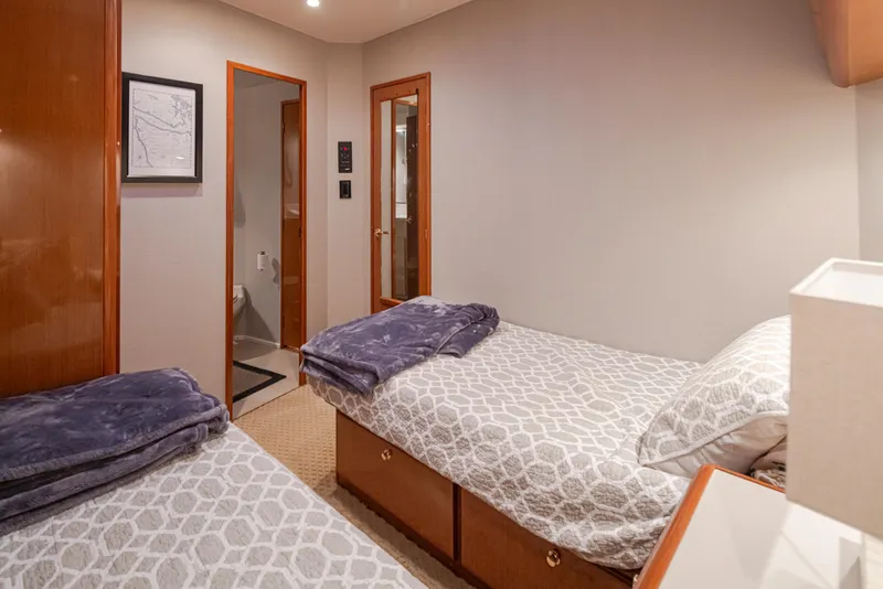 Slide: The Image of Cozy twin bedroom on a 2000 Viking 72 Convertible yacht. - 23