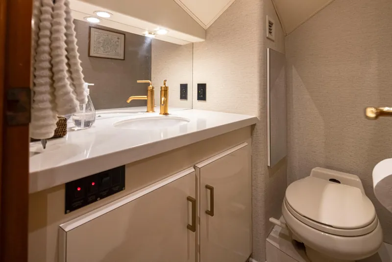 Slide: The Image of Luxurious bathroom in a 2000 Viking 72 Convertible yacht with modern fixtures. - 30