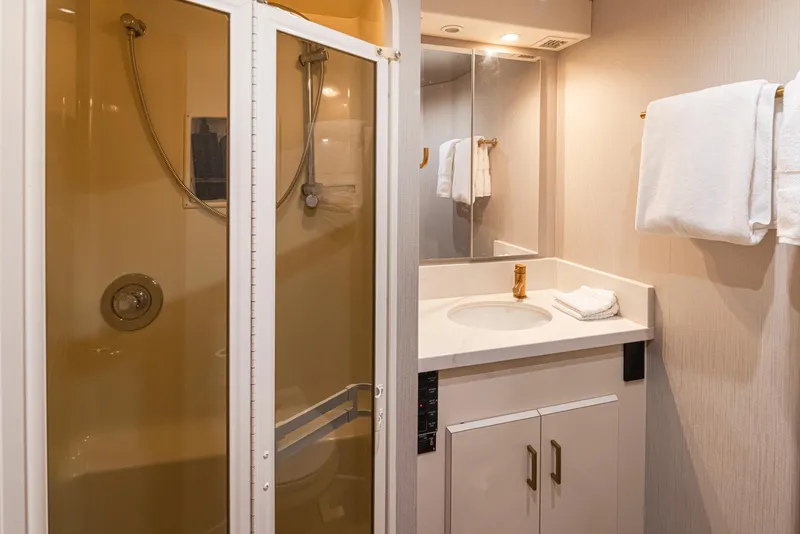 Slide: The Image of Bathroom in 2000 Viking 72 Convertible yacht with shower, sink, and towels. - 32