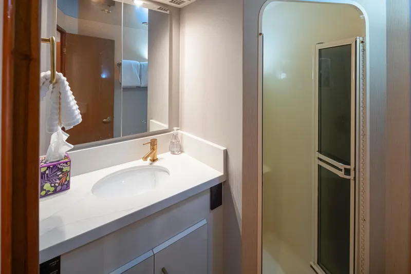 Slide: The Image of Bathroom interior of 2000 Viking 72 Convertible yacht with sink and shower. - 34