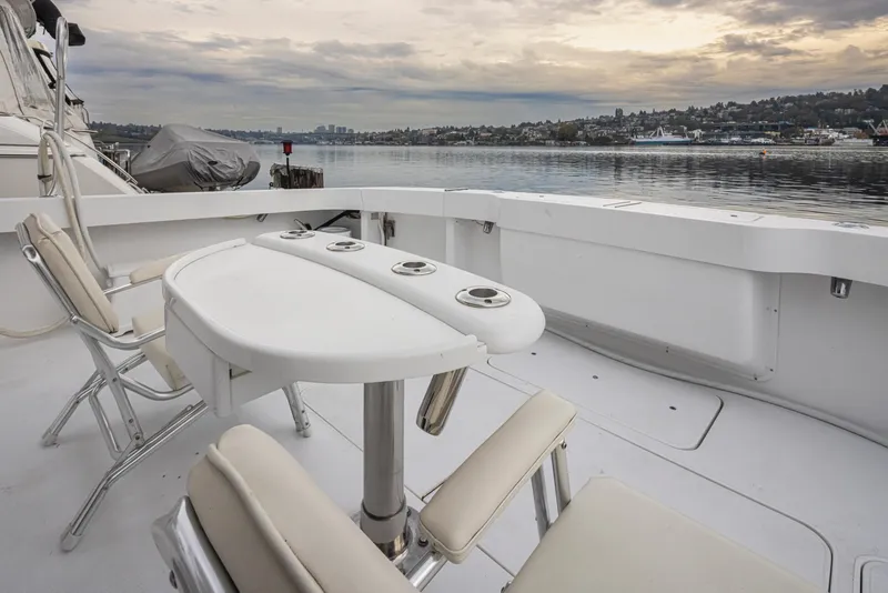 Slide: The Image of Viking 72 Convertible 2000 yacht deck with chairs and table, overlooking calm waters. - 38