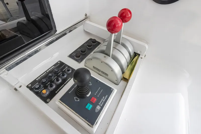 Slide: The Image of Control panel of a 2000 Viking 72 Convertible yacht with throttle levers and joystick. - 39
