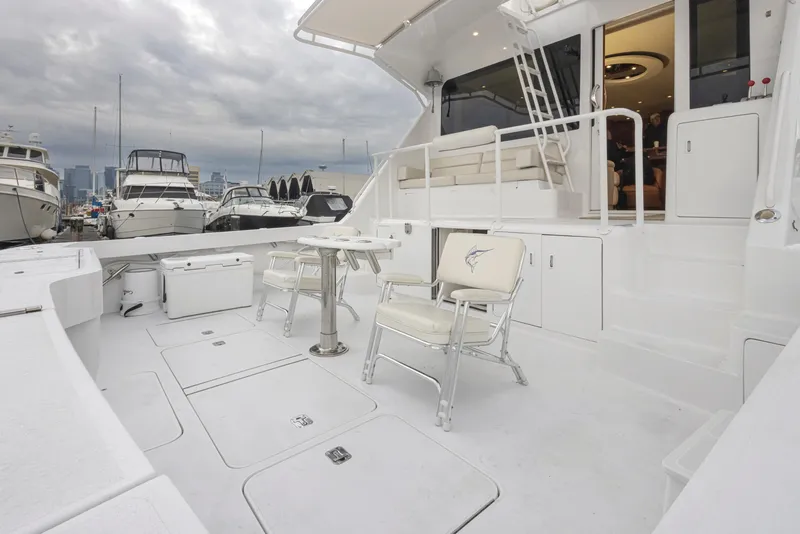 Slide: The Image of Viking 72 Convertible 2000 yacht deck with seating and table, docked at marina. - 40