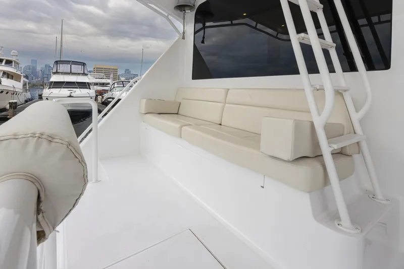 Slide: The Image of Viking 72 Convertible 2000 yacht with beige seating on deck, docked at marina. - 43