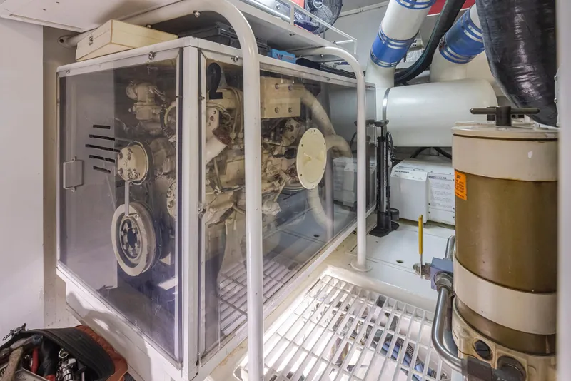 Slide: The Image of Engine room of a 2000 Viking 72 Convertible yacht with visible machinery. - 44