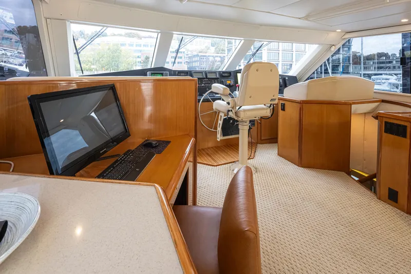 Slide: The Image of Interior of 2000 Viking 72 Convertible yacht with helm station and navigation desk. - 5