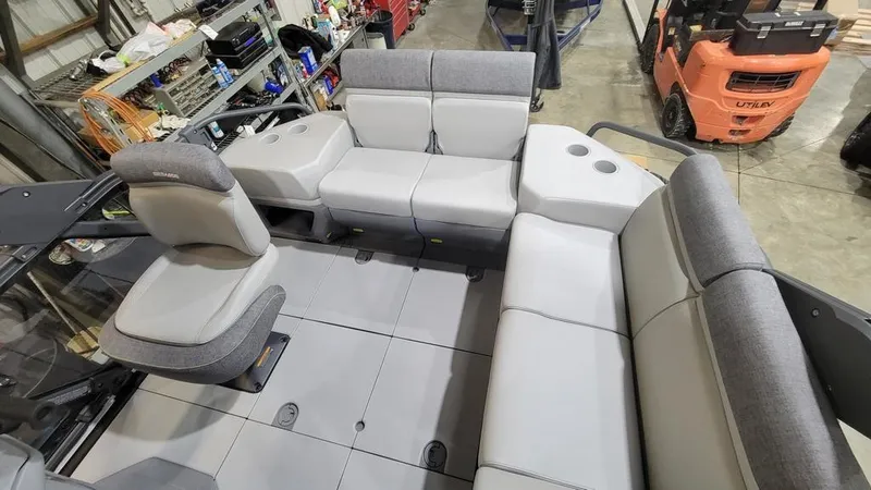 Slide: The Image of 2023 Sea-Doo Switch® Cruise 18-170 hp interior seating in a workshop. - 10
