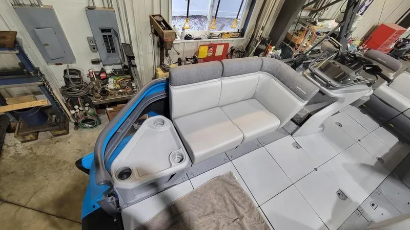 Slide: The Image of 2023 Sea-Doo Switch® Cruise 18-170 hp interior seating and console in a workshop. - 7
