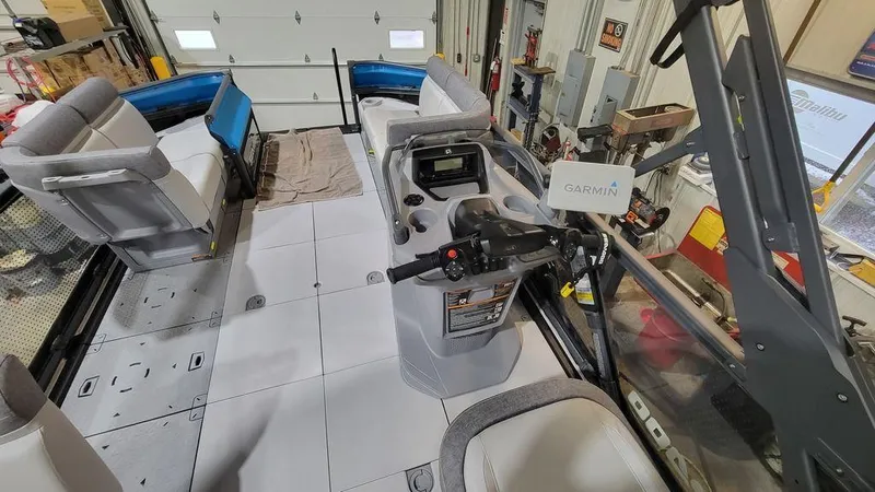 Slide: The Image of 2023 Sea-Doo Switch® Cruise 18-170 hp interior with Garmin navigation system in a garage. - 9