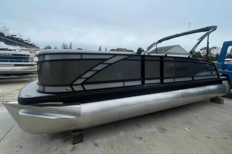 Slide: The Image of 2023 Godfrey Monaco 235 SFL pontoon boat in a marina. - 0