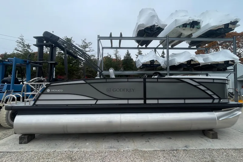 Slide: The Image of 2023 Godfrey Monaco 235 SFL pontoon boat in storage yard. - 1
