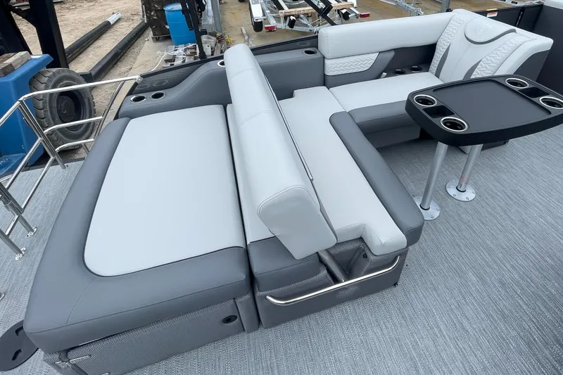 Slide: The Image of 2023 Godfrey Monaco 235 SFL boat interior with gray and white seating and a black table. - 13