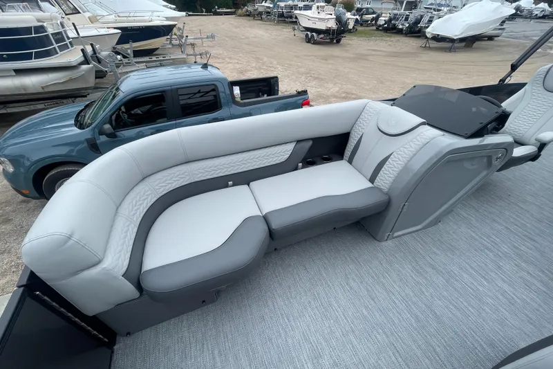 Slide: The Image of 2023 Godfrey Monaco 235 SFL boat interior with gray seating and dashboard. - 18