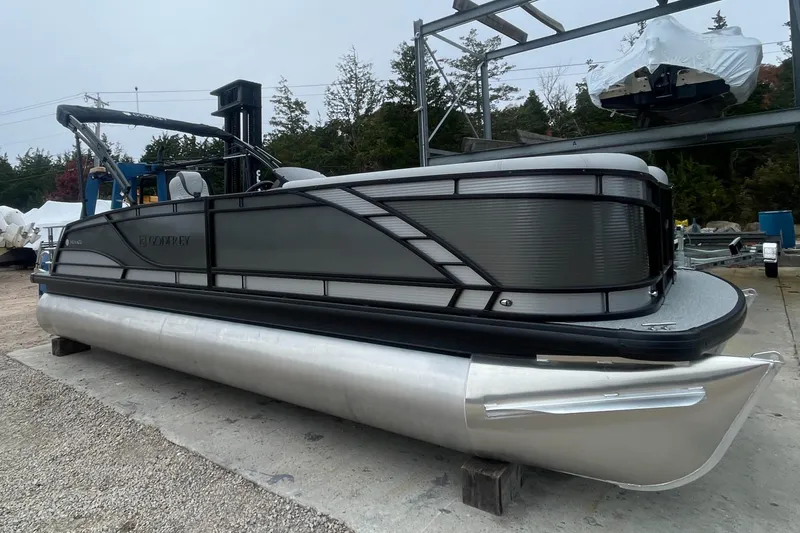 Slide: The Image of 2023 Godfrey Monaco 235 SFL pontoon boat in a storage yard. - 2