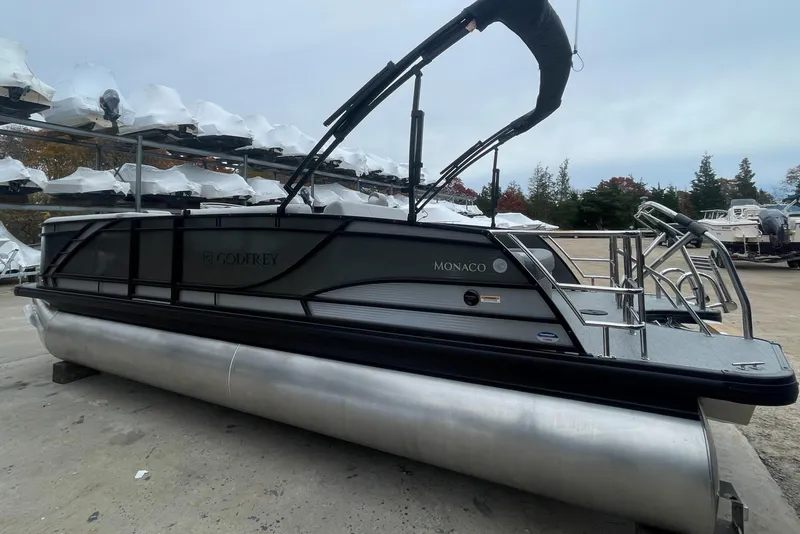Slide: The Image of 2023 Godfrey Monaco 235 SFL pontoon boat with sleek black design and modern features. - 4