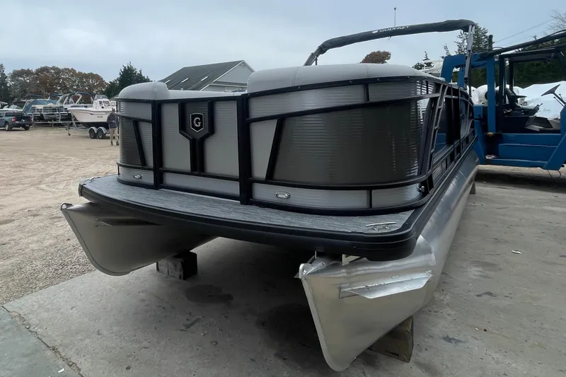 Slide: The Image of 2023 Godfrey Monaco 235 SFL pontoon boat on a trailer in a marina. - 5