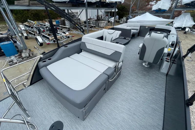 Slide: The Image of 2023 Godfrey Monaco 235 SFL pontoon boat interior with gray seating and helm. - 8