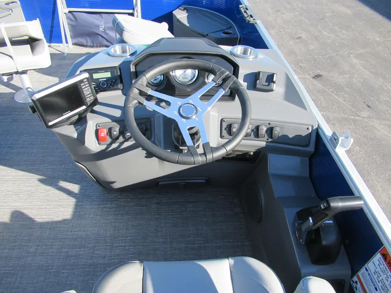 Slide: The Image of 2024 Bennington 188 SVF boat cockpit with steering wheel and control panel. - 2