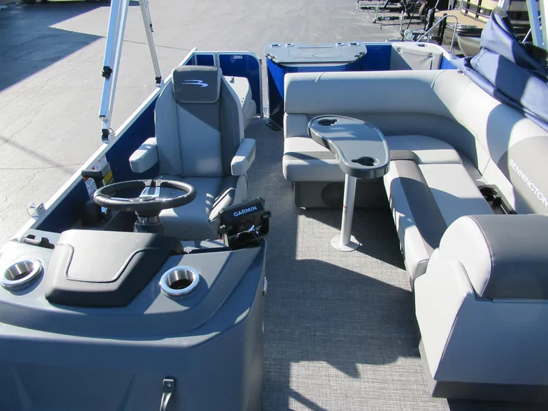 Slide: The Image of 2024 Bennington 188 SVF pontoon boat interior with seating and steering console. - 4