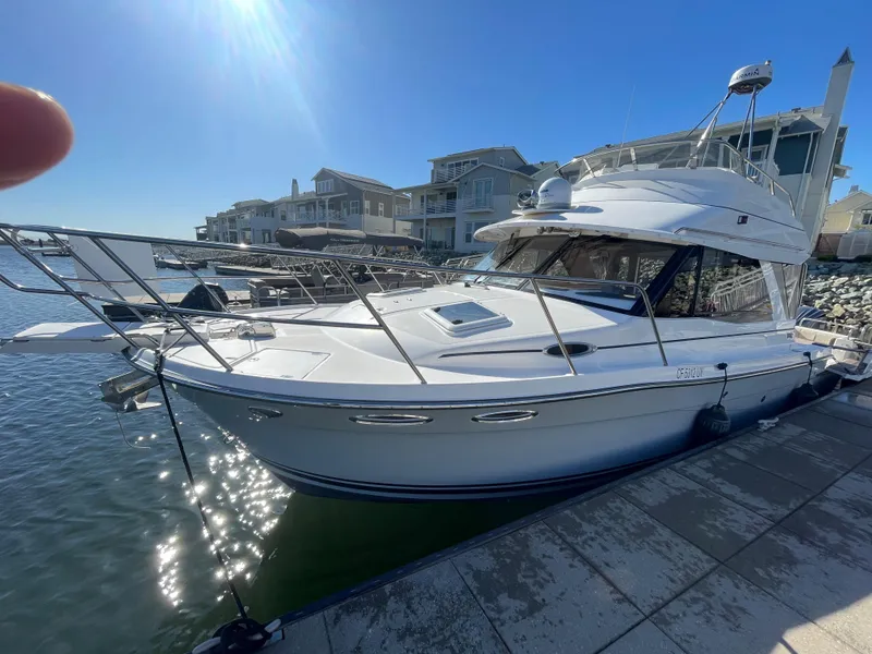 The Image of 2022 Cutwater Flybridge boat docked at marina under clear blue sky. - 0