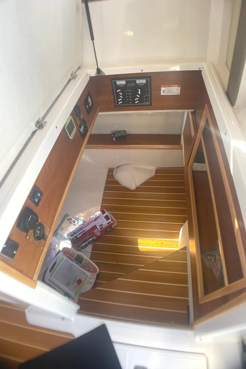 Slide: The Image of 2022 Cutwater Flybridge interior with wood paneling and control panels. - 13