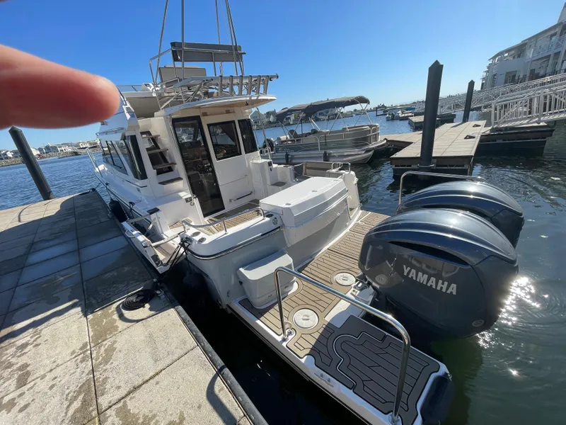 Slide: The Image of 2022 Cutwater Flybridge boat docked with Yamaha engines, sunny marina setting. - 14