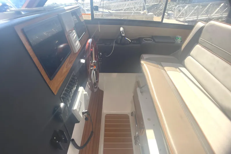 Slide: The Image of 2022 Cutwater Flybridge interior with steering wheel, dashboard, and seating area. - 20