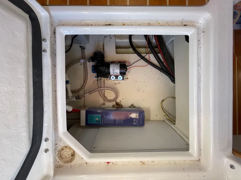 Slide: The Image of 2022 Cutwater Flybridge compartment with pump and wiring. - 25