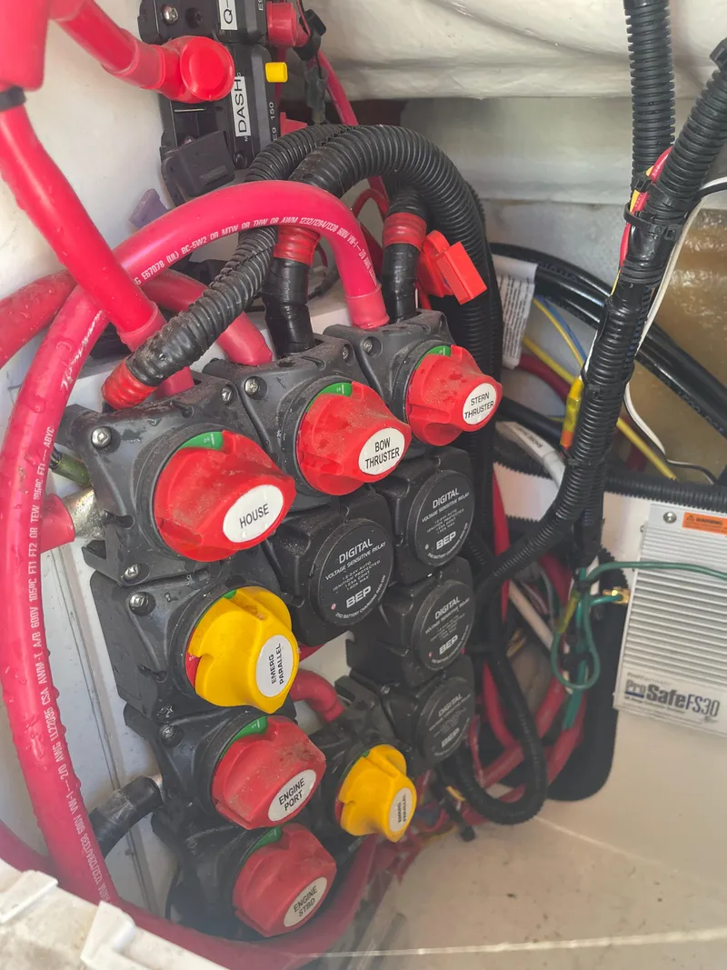 Slide: The Image of Electrical panel with switches and wiring in a 2022 Cutwater Flybridge boat. - 27