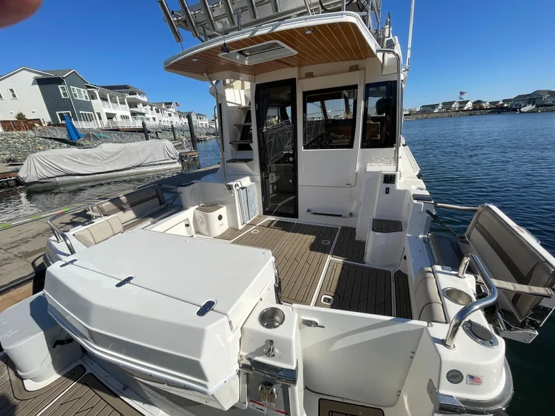 Slide: The Image of 2022 Cutwater Flybridge boat docked, featuring spacious deck and modern design. - 32