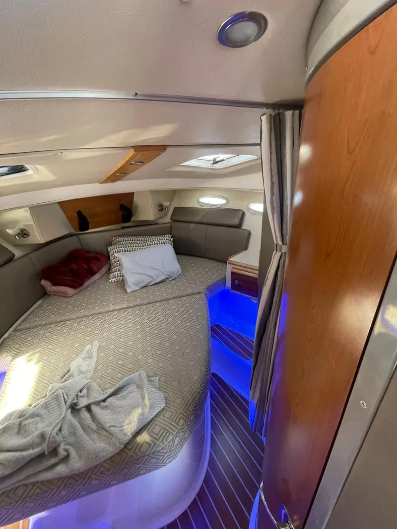 Slide: The Image of 2022 Cutwater Flybridge cabin interior with cozy bed and ambient lighting. - 6