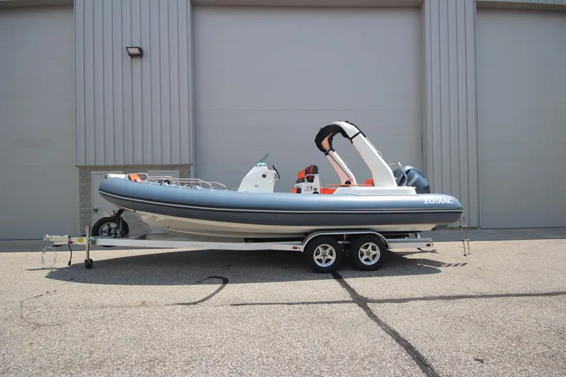 The Image of 2024 Zodiac Medline 7.5 NEO 300hp boat on trailer, parked outdoors. - 0