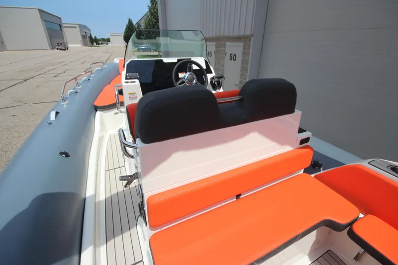 Slide: The Image of 2024 Zodiac Medline 7.5 NEO boat with orange seating, docked outdoors. - 15