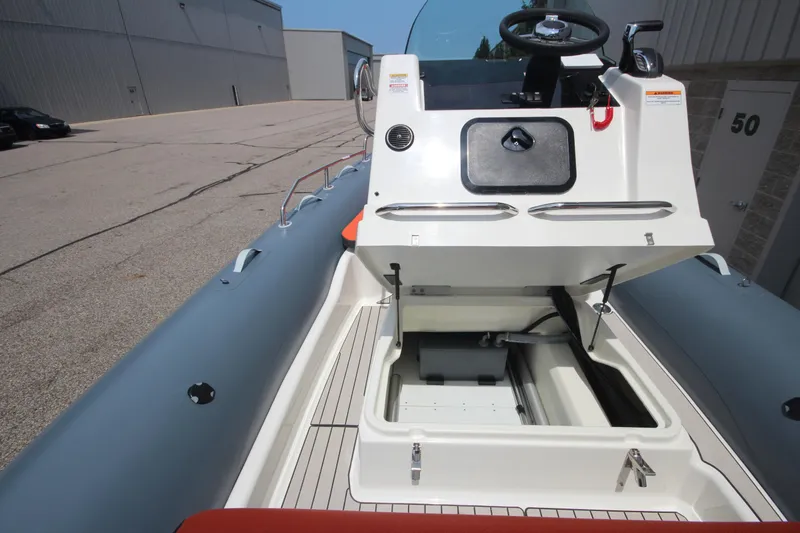 Slide: The Image of 2024 Zodiac Medline 7.5 NEO boat interior with open storage compartment. - 23