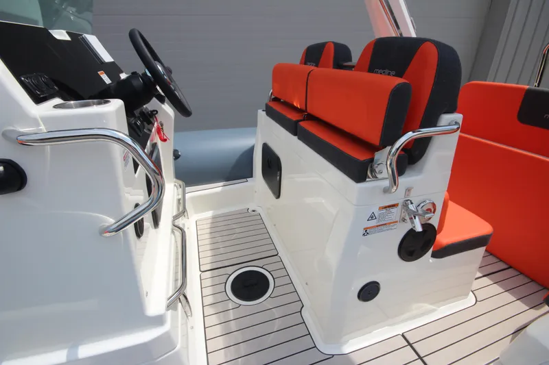 Slide: The Image of 2024 Zodiac Medline 7.5 boat interior with orange seating and modern controls. - 27