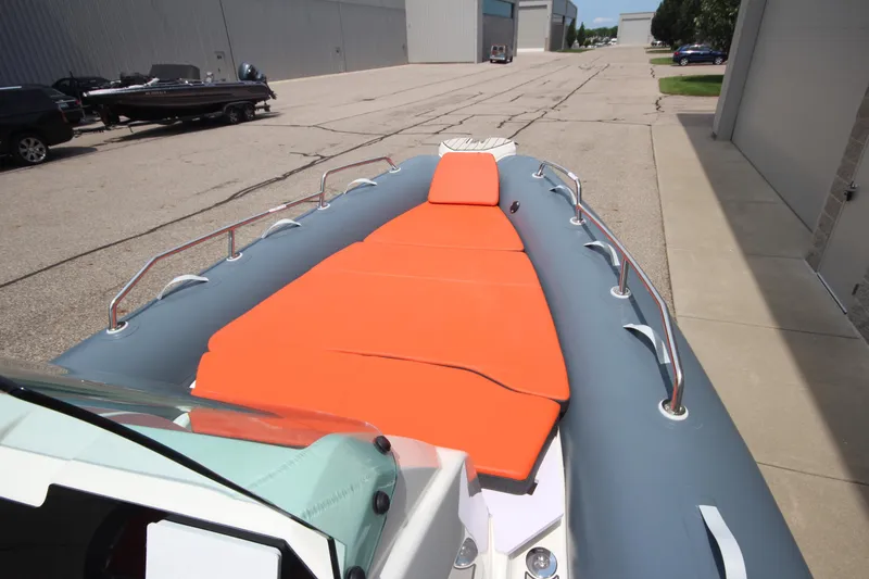 Slide: The Image of 2024 Zodiac Medline 7.5 NEO boat with orange seating, docked outdoors. - 31