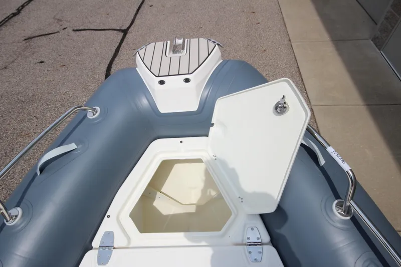 Slide: The Image of 2024 Zodiac Medline 7.5 NEO boat with open storage compartment, gray and white design. - 34