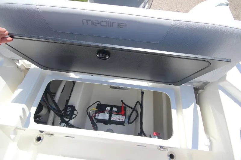 Slide: The Image of 2025 Zodiac Medline 5.8 NEO boat storage compartment with battery and wiring. - 15