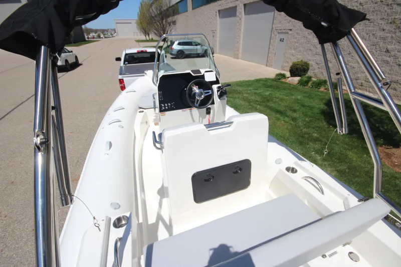 Slide: The Image of 2025 Zodiac Medline 5.8 NEO boat with 115hp engine, parked outdoors. - 16