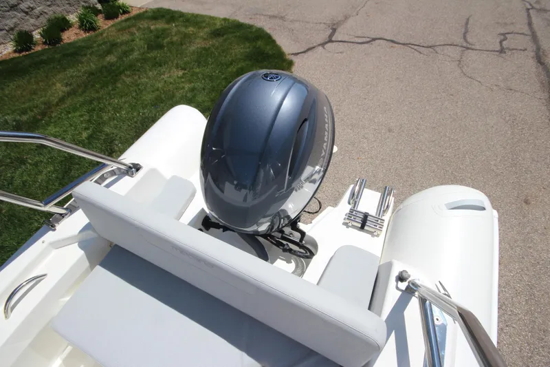 Slide: The Image of 2025 Zodiac Medline 5.8 NEO boat with 115hp engine, rear view on pavement. - 17