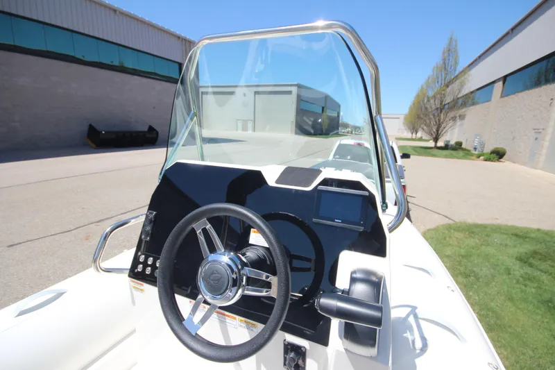 Slide: The Image of 2025 Zodiac Medline 5.8 NEO boat dashboard with steering wheel and controls. - 18