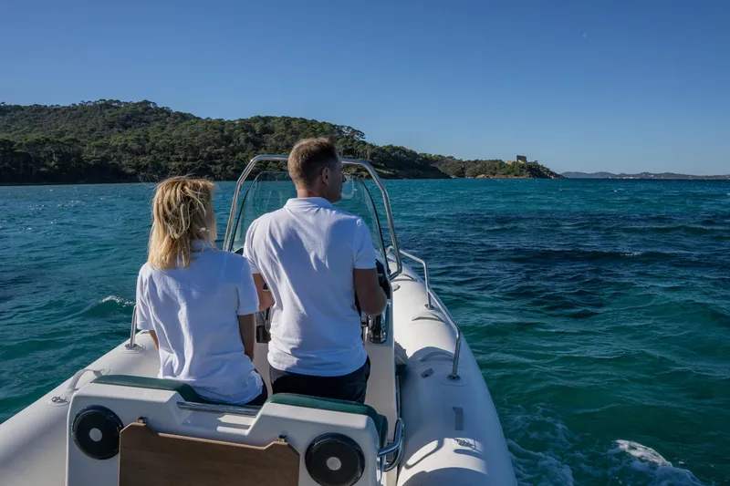 Slide: The Image of Couple enjoying a ride on a 2025 Zodiac Medline 5.8 NEO boat in clear blue waters. - 27