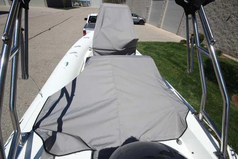 Slide: The Image of 2025 Zodiac Medline 5.8 NEO boat with protective cover, parked outdoors. - 6