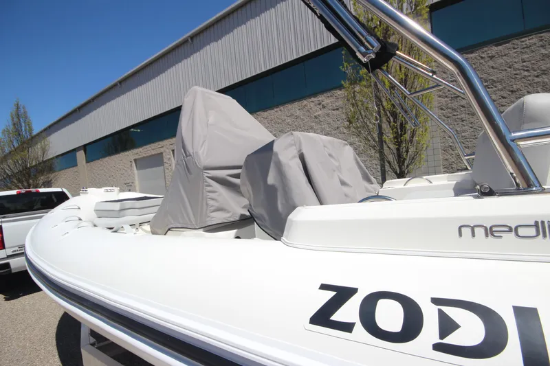 Slide: The Image of 2025 Zodiac Medline 5.8 NEO boat with 115hp engine, covered seats, outdoor display. - 9